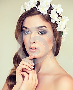 Beautiful girl with a wreath of flowers on her head.