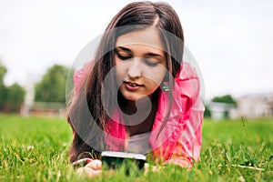 Beautiful girl writing sms on your smartphone