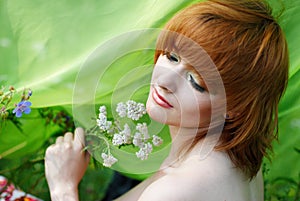 Beautiful girl with yarrow herb