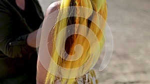 A beautiful girl with a yellow kanekalon on her hair and pigtails.