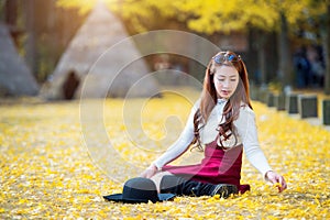 Beautiful Girl with Yellow Leaves in Nami Island.