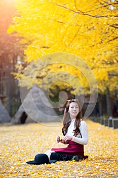 Beautiful Girl with Yellow Leaves in Nami Island.