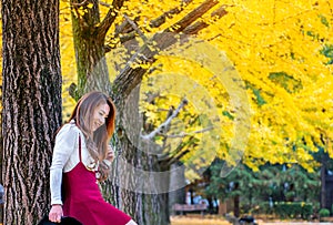 Beautiful Girl with Yellow Leaves in Nami Island.