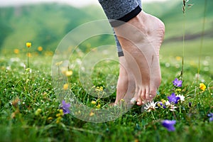 Beautiful girls barefoot in cool morning dew on grass. photo