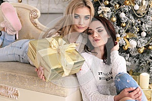 beautiful girls in cozy home clothes celebrating New Year holidays