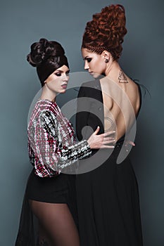 Beautiful girls in evening dress with avant-garde hairstyles. Beauty the face.