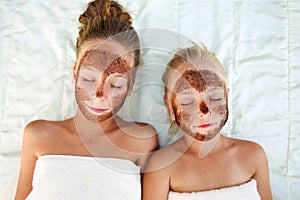 Beautiful girls with facial mask coffee scrub.