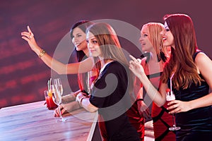 Beautiful girls ordering drinks at the bar