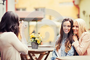 Beautiful girls taking picture in cafe in city