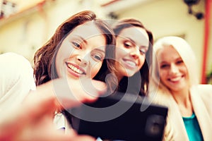 Beautiful girls taking picture in cafe in city