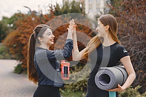 Sports girls training in a summer forest