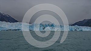 Beautiful glacier Perito Moreno. A wall of blue ice rises above a turquoise glacial lake.