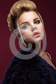 Beautiful glamor blondie woman in fur coat , evening makeup and hairstyle. The beauty of the face.