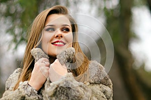 Beautiful glamorous lady having fun outdoor on gloomy winter day