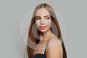 Beautiful glamorous woman fashion model with long straight healthy hair and makeup posing on white background
