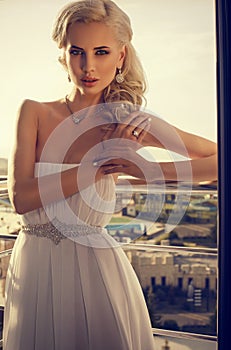 Beautiful glamour bride with blond hair in elegant dress