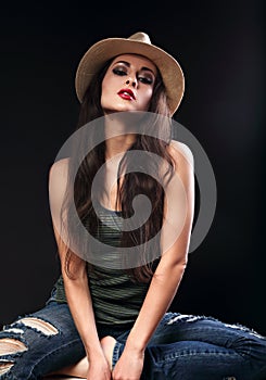 Beautiful glamour female model in cowboy summer hat posing