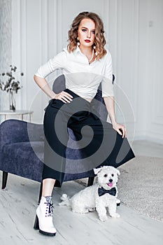 Beautiful glamour woman in sunglasses with small dog in hands
