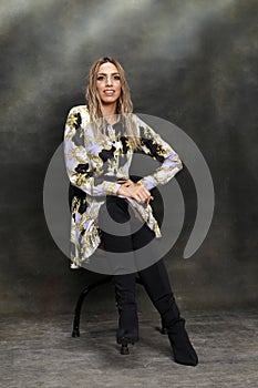 Beautiful, glamourous blonde girl posing in studio on isolated background. Style, trends, fashion concept.