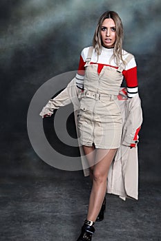 Beautiful, glamourous blonde girl posing in studio on isolated background. Style, trends, fashion concept.