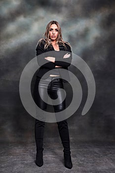 Beautiful, glamourous blonde girl posing in studio on isolated background. Style, trends, fashion concept.