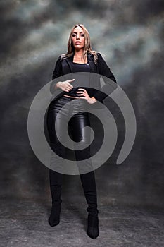 Beautiful, glamourous blonde girl posing in studio on isolated background. Style, trends, fashion concept.