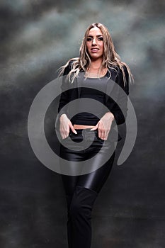 Beautiful, glamourous blonde girl posing in studio on isolated background. Style, trends, fashion concept.