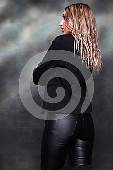 Beautiful, glamourous blonde girl posing in studio on isolated background. Style, trends, fashion concept.