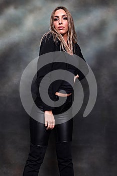 Beautiful, glamourous blonde girl posing in studio on isolated background. Style, trends, fashion concept.