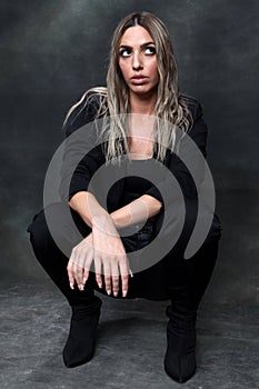 Beautiful, glamourous blonde girl posing in studio on isolated background. Style, trends, fashion concept.