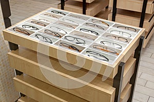 Beautiful glasses on the display shelf. Exhibitor of glasses. Optician