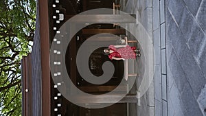 Beautiful, glasses-toting hispanic woman indulging in tranquil solitude while sitting on a bench at tokyo\'s meiji temple, taking