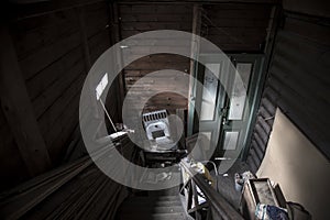 Beautiful and gloomy interior of an old abandoned house. Antique staircase and wooden door.