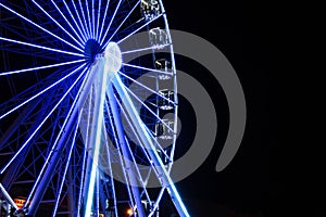 Beautiful glowing Ferris wheel against dark sky. Space for text