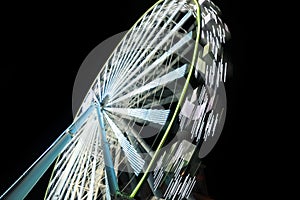 Beautiful glowing Ferris wheel against sky, motion blur effect