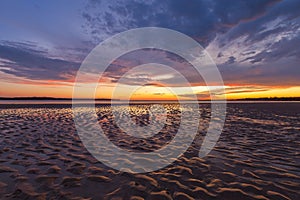 Beautiful glowing sunset reflections in sand ripples, Inverloch, Australia