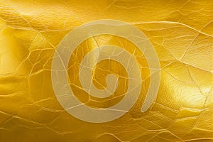 Beautiful golden background with leather texture. Gold leather as sample of gold background from natural leather.