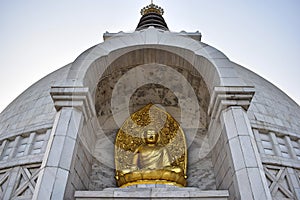 Beautiful Golden Buddha statue in Shanti Stupa Temple in Delhi