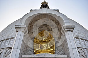 Beautiful Golden Buddha statue in Shanti Stupa Temple in Delhi photo