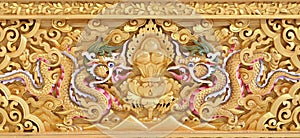 Beautiful golden carving of the dragon on the sanctuary Buddhist church wall photo