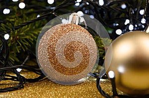 Beautiful golden Christmas glitter ball with light Christmas garland stock images