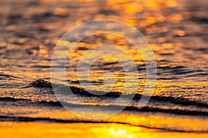 Beautiful golden colors of sunset over sea waves