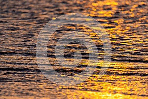 Beautiful golden colors of sunset over sea waves