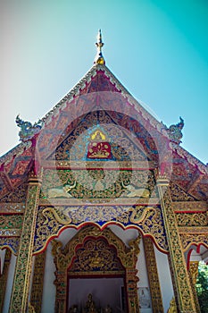 Beautiful golden craving on the entrance gable of the church at Wat Phra That Doi Tung, one of which is believed to contain the le