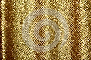 Beautiful golden glitter background with golden sequins. Sparkling sequined textile