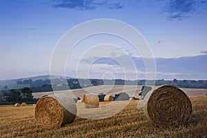 Beautiful golden hour hay bales sunset landscape