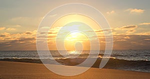 Beautiful golden light at sunset on the beach, with reflections on the ocean surface