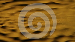 Beautiful golden light water surface with circles and waves, abstract background, wallpaper template.