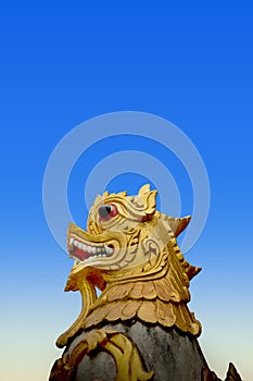 Beautiful golden lion sculpture with blue sky Located along the cliff on the mountain in Phra That Doi Kong Mu Temple