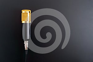 Beautiful golden microphone on a black background, copy space.